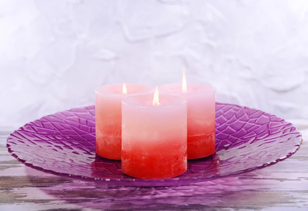 Beautiful candles on table on grey background — Stock Photo, Image