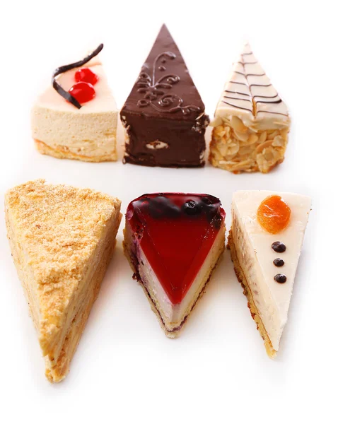 Assortiment van stukken van cake, geïsoleerd op wit — Stockfoto