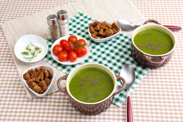 Tasty soup in saucepans on tablecloth, close up — Stock Photo, Image