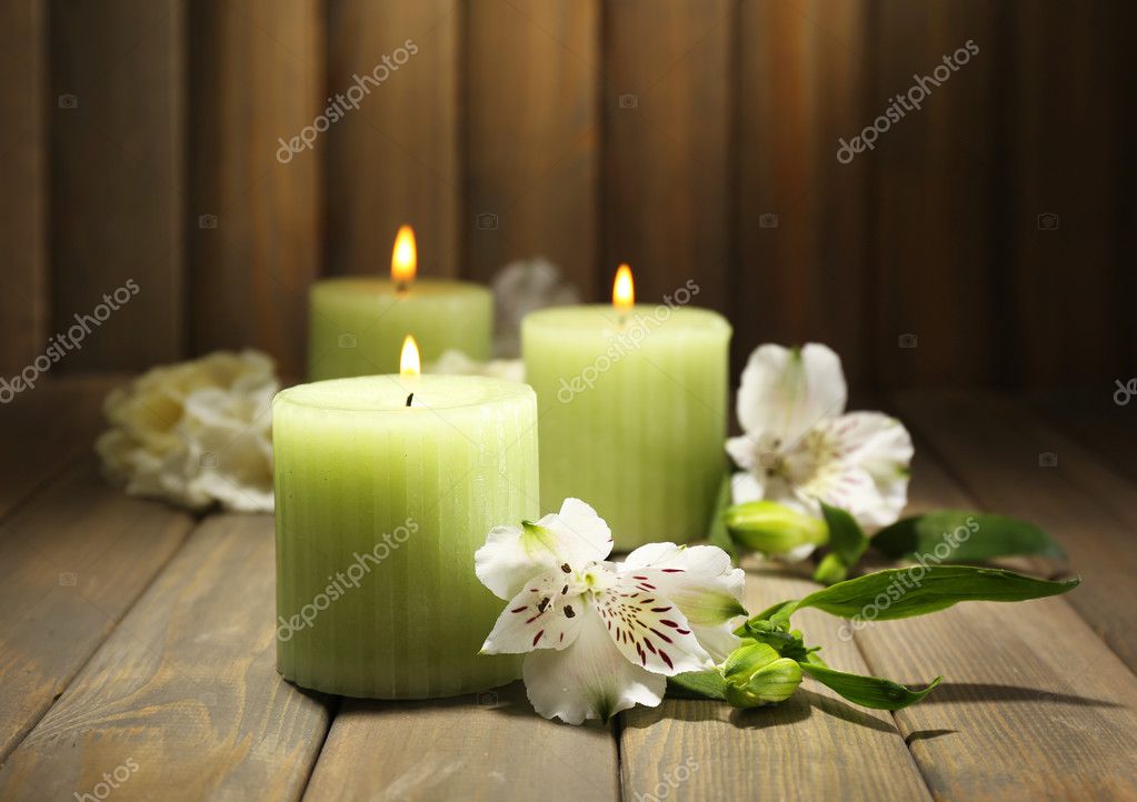 Beautiful candles with flowers on wooden background — Stock Photo