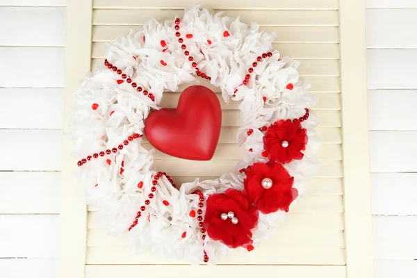 Decorative wreath with heart on wooden background — Stock Photo, Image