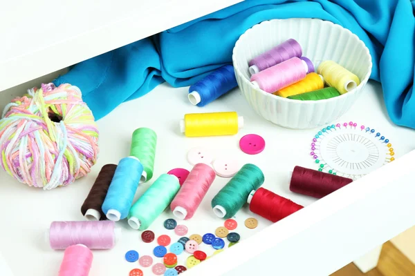 Sewing accessories in open drawer close up — Stock Photo, Image