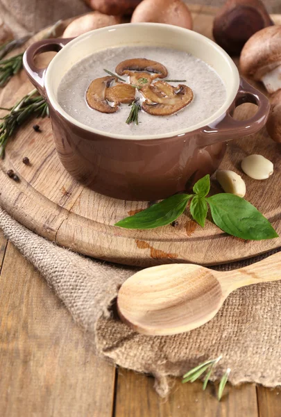 Mushroom soup in pot, on napkin,  on wooden background — Stock Photo, Image