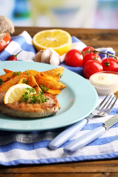 Bife grelhado, legumes grelhados e pedaços de batata frita na mesa, no fundo brilhante — Fotografia de Stock