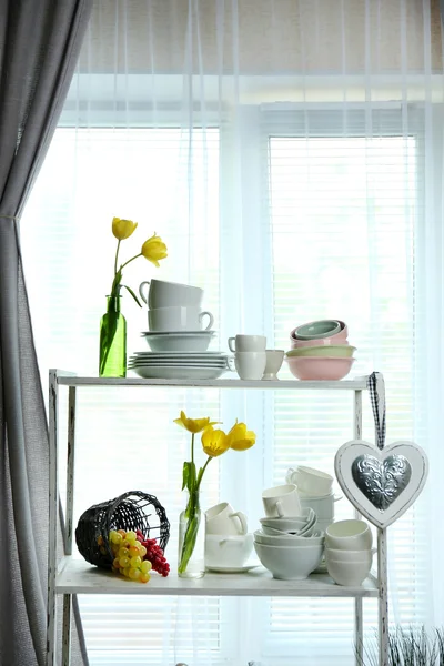 Different tableware on shelf in the interior — Stock Photo, Image