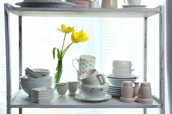 Different tableware on shelf in the interior — Stock Photo, Image