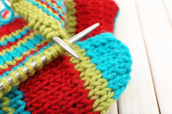 Knitting with spokes on wooden background — Stock Photo, Image