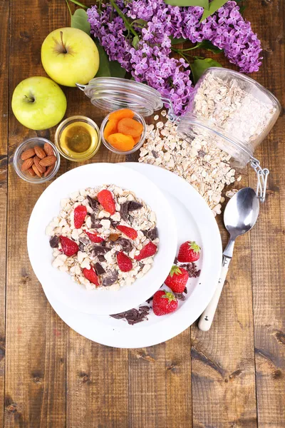 Healthy cereal with fruits on wooden table — Stock Photo, Image