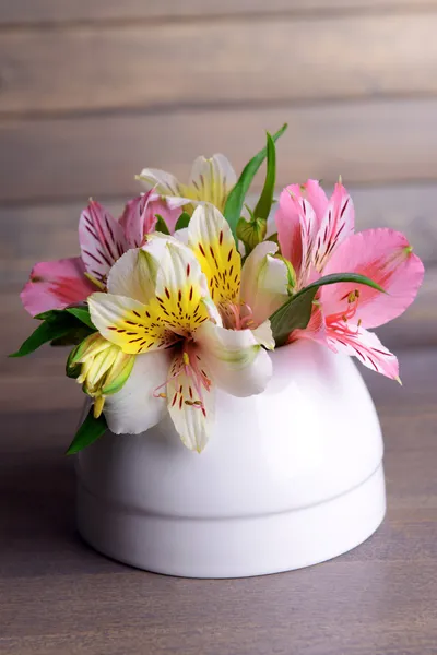 Alstroemeria flowers in vase on table on grey background — Stock Photo, Image