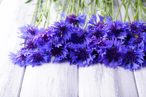 Beautiful cornflowers on wooden background — Stock Photo, Image