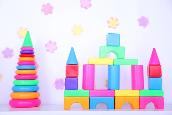 Colorful plastic toys on decorative — Stock Photo, Image