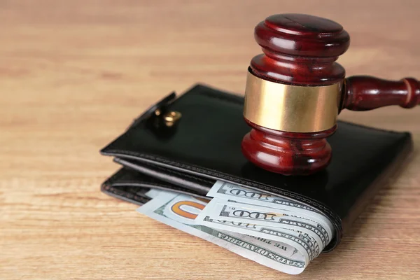 Gavel and money in wallet on wooden background — Stock Photo, Image