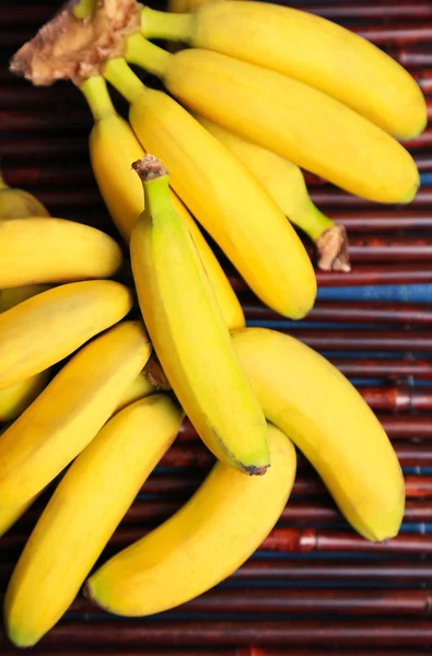 Bunch of mini bananas on bamboo mat background — Stock Photo, Image