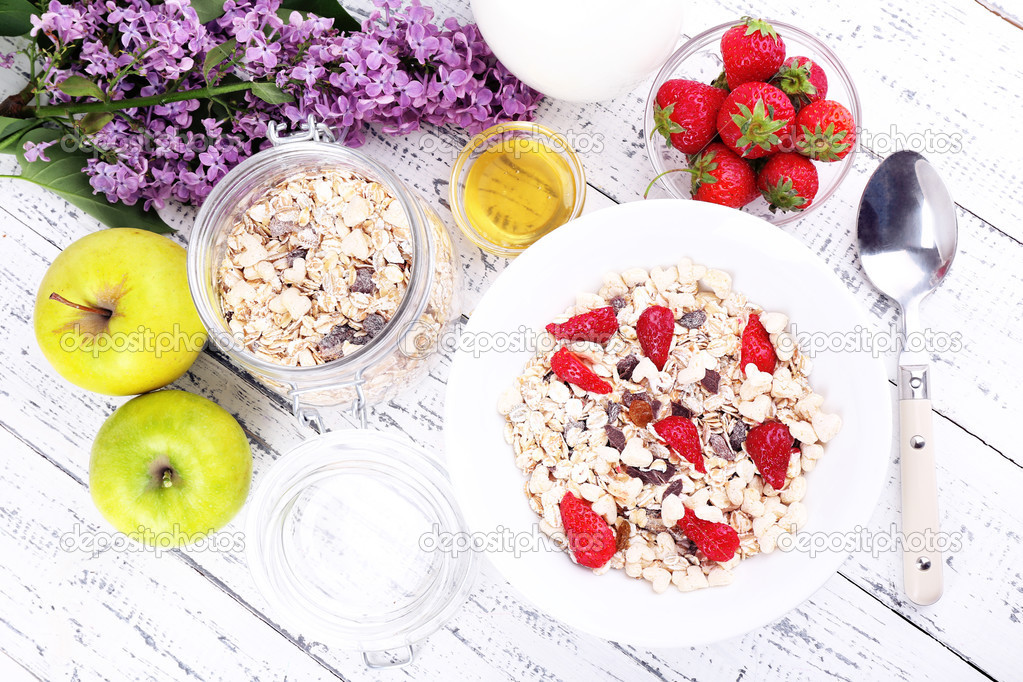 Healthy cereal with milk and fruits on wooden table