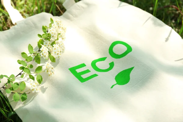 Eco bag on green grass, outdoors — Stock Photo, Image