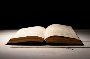 siyah arka plan üzerine masada eski kitap