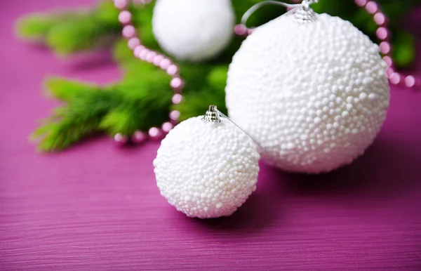 Christmas balls on fir tree, on color background — Stock Photo, Image