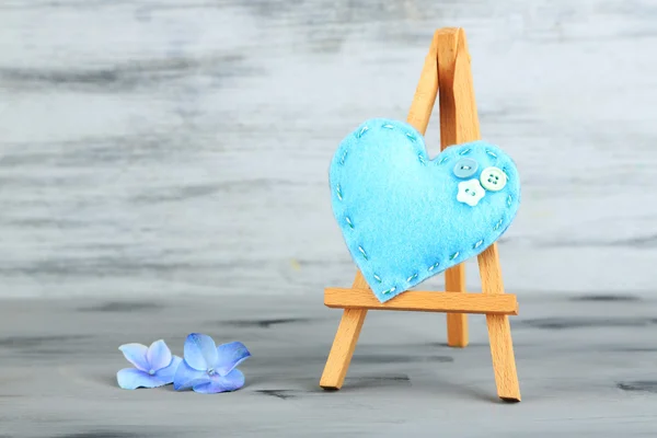 Gyönyörű szív kis dekoratív festőállvány a szürke háttér — Stock Fotó
