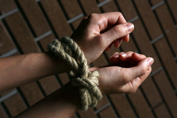 Tied hands on dark background