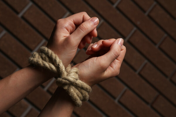 Tied hands on dark background