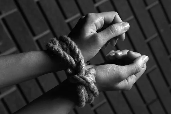 Tied hands in shades of grey — Stock Photo, Image