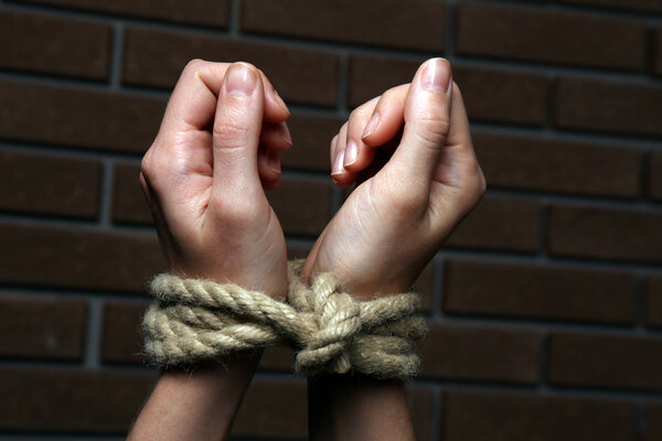 Tied hands on dark background