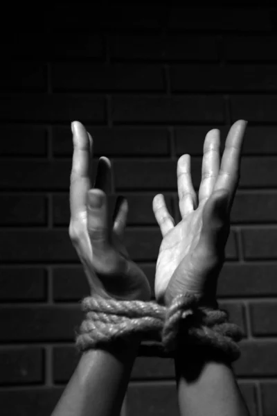 Tied hands in shades of grey — Stock Photo, Image