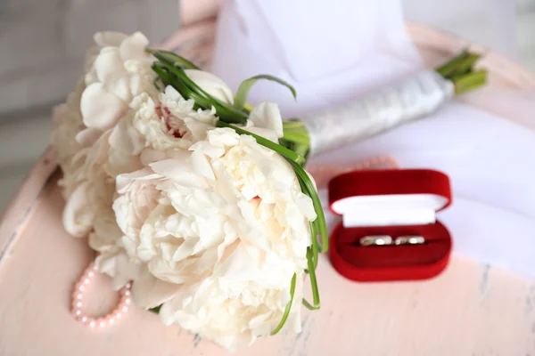 Beautiful wedding bouquet on   wooden chair on light background — Stock Photo, Image