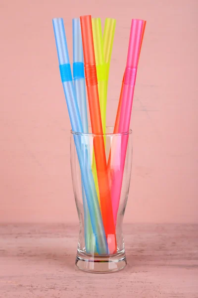 Straws in glass on pink background — Stock Photo, Image