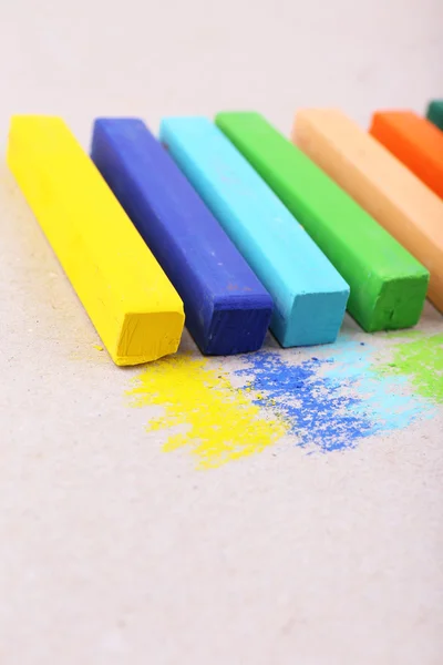 Colorful chalk pastels on color paper background — Stock Photo, Image