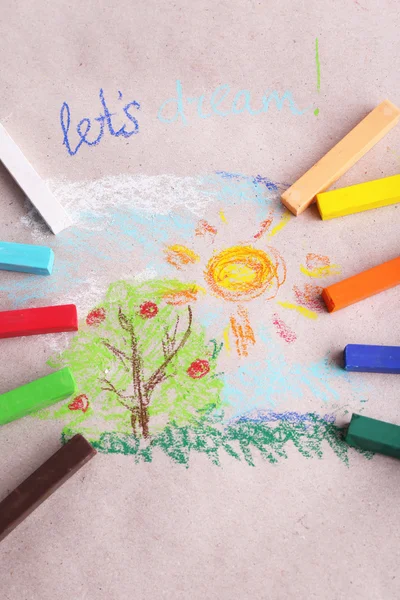 Colorful chalk pastels and simple picture on color paper background — Stock Photo, Image