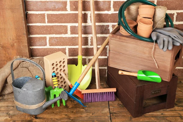 Tools of gardener on  bricks background — Stock Photo, Image