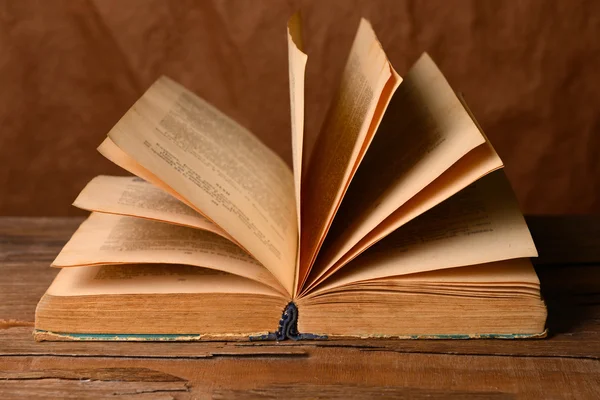 Libro viejo sobre la mesa sobre fondo marrón — Foto de Stock