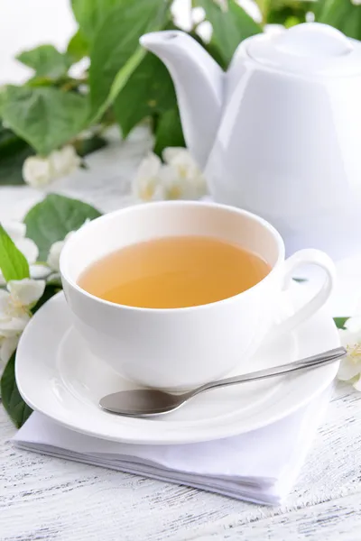 Cup of tea with jasmine on table close-up — Stock Photo, Image