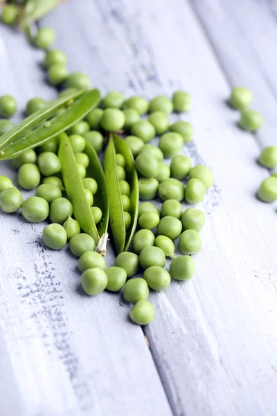 Fresh green peas on wooden background — Stock Photo, Image
