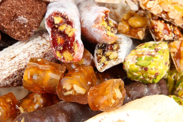 Tasty oriental sweets, on brown background — Stock Photo, Image