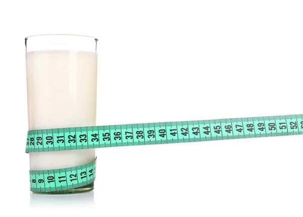 Glass of milk with measuring tape isolated on white — Stock Photo, Image