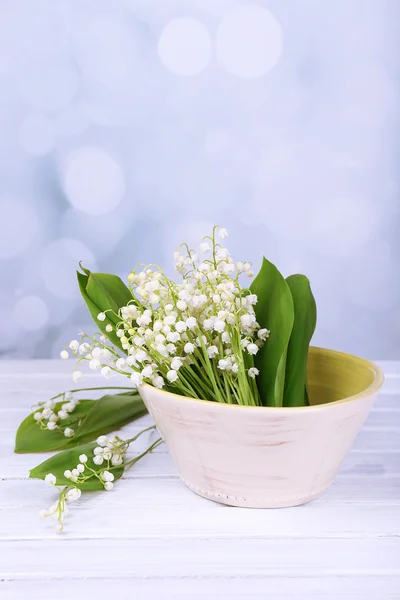 Beautiful lilies of the valley in vase on wooden table — Stock Photo, Image