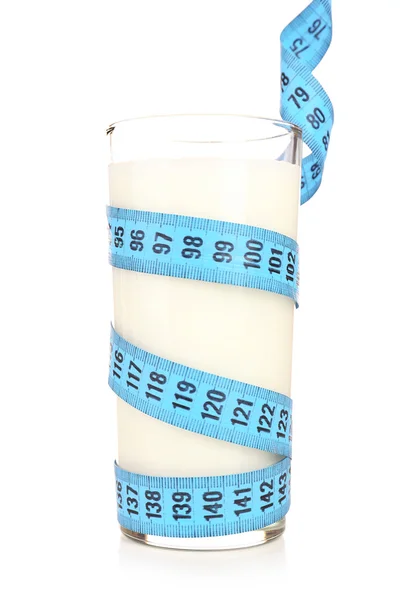 Стакан молока с измерительной лентой, изолированной на белом — стоковое фото