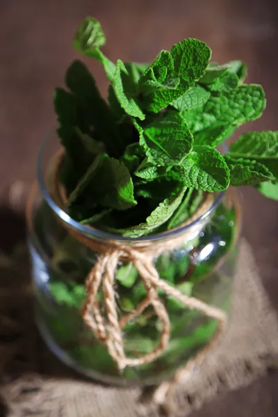 Mint in glass jar on wooden background — Stock Photo, Image