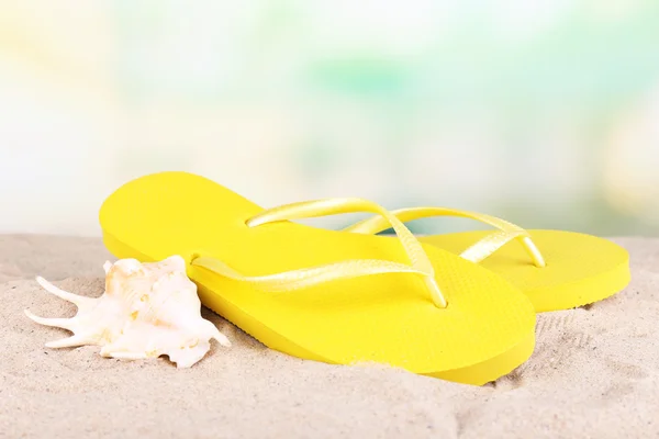 Bright flip-flops on sand, on nature background — Stock Photo, Image