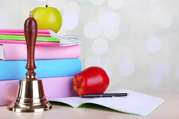 Gold school bell with school supplies — Stock Photo, Image