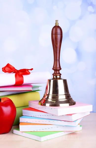 Gold school bell with school supplies — Stock Photo, Image