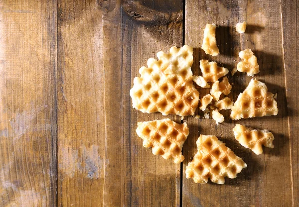 Crushed waffle on wooden background — Stock Photo, Image