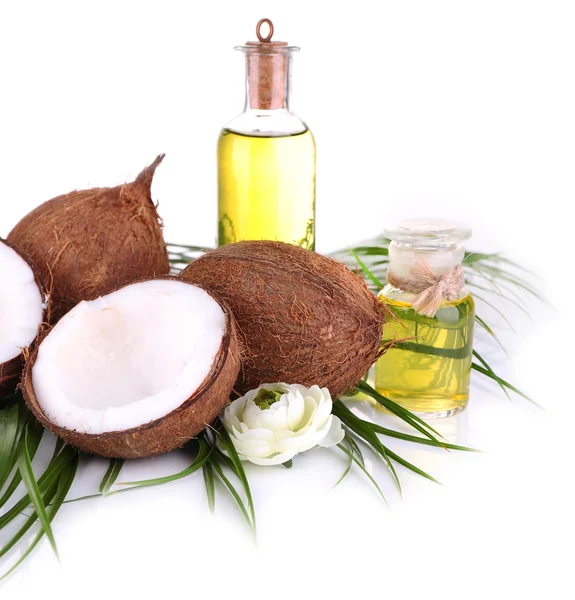 Coconuts and coconut oil, isolated on white — Stock Photo, Image