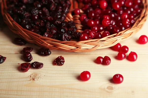 Fresh and dry cranberry on wicker mat on wooden table close-up — Stock Photo, Image