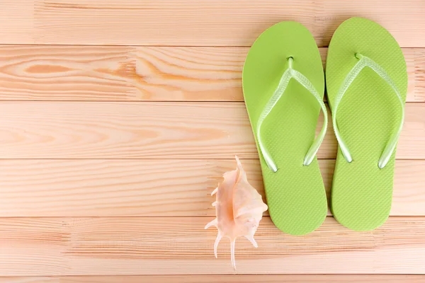 Bright flip-flops on wooden background — Stock Photo, Image