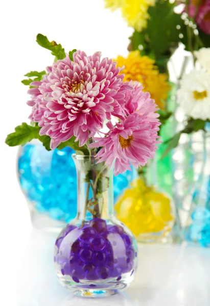 Beautiful flowers in vases with hydrogel close up — Stock Photo, Image