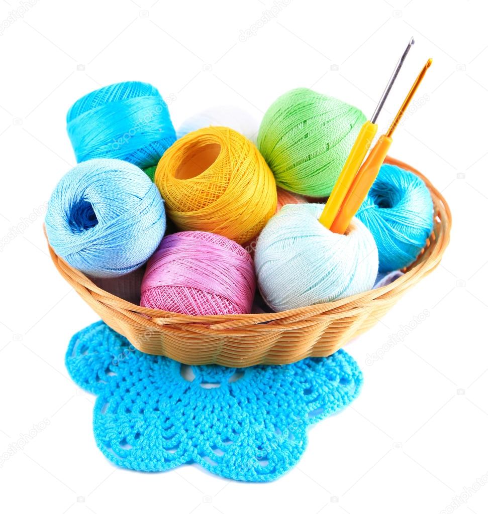 Colorful yarn for knitting with napkin in wicker basket and crochet