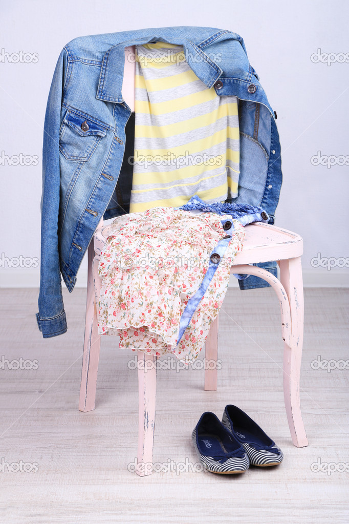 Clothes on chair on gray background